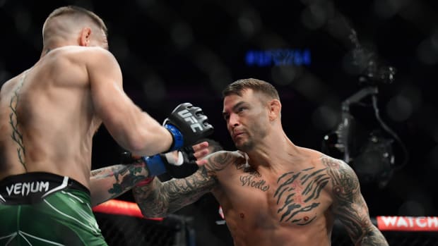 Dustin Poirier moves in for a hit against Conor McGregor during UFC 264 at T-Mobile Arena.